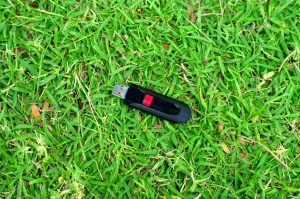usb flash drive on grass background